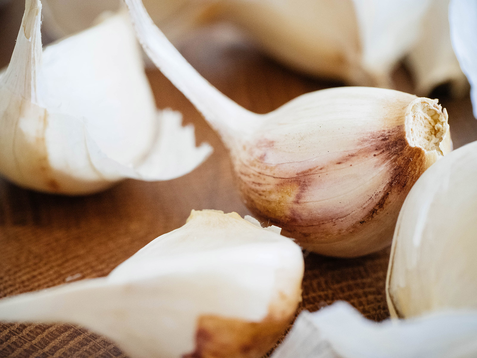 Close-up of Oregon Blue garlic cloves on a wooden surface