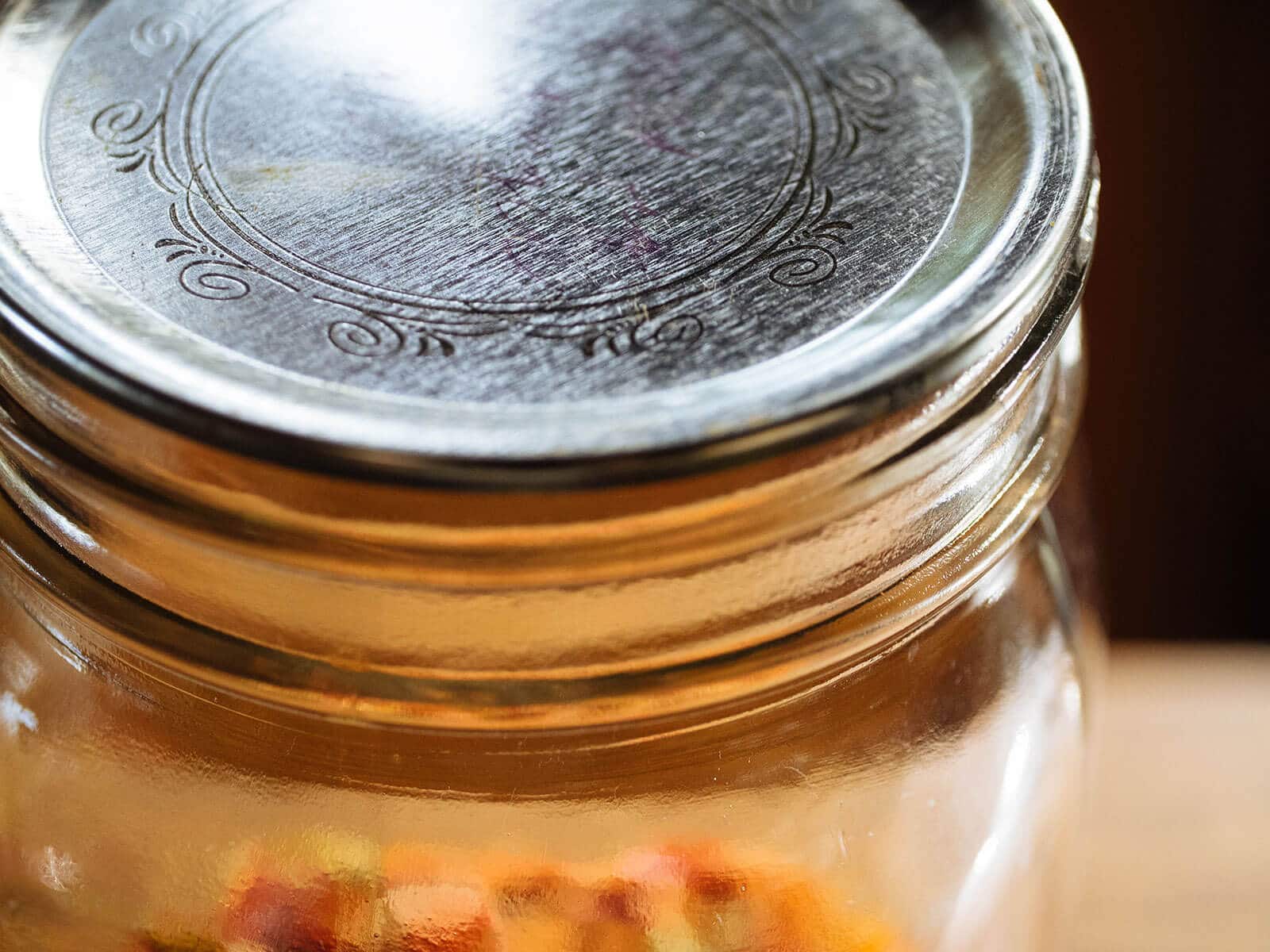 Jar with canning lid placed on top of it