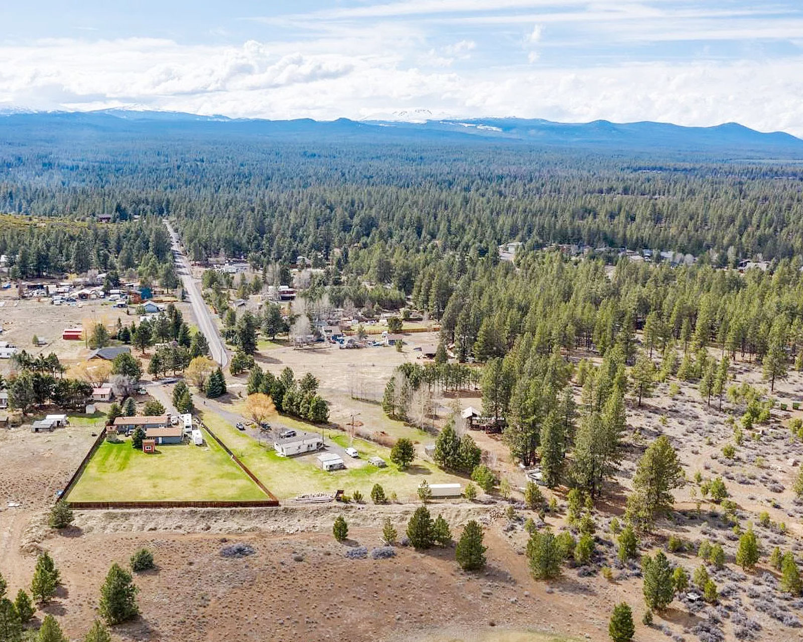 Aerial view of a wooded neighborhood dotted with houses